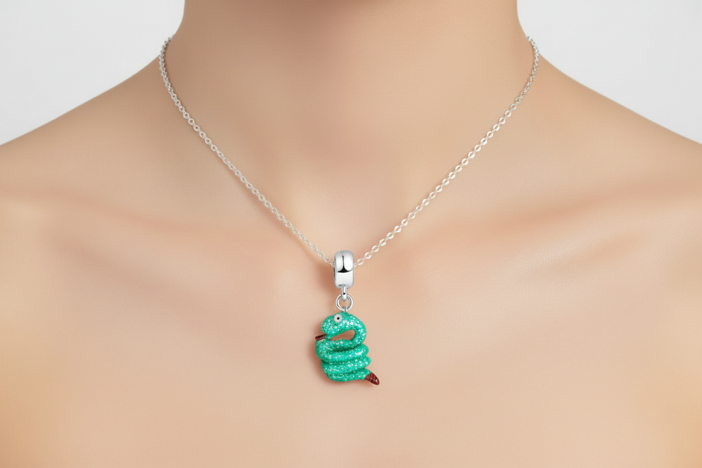 Green snake-shaped pendant on a silver chain 