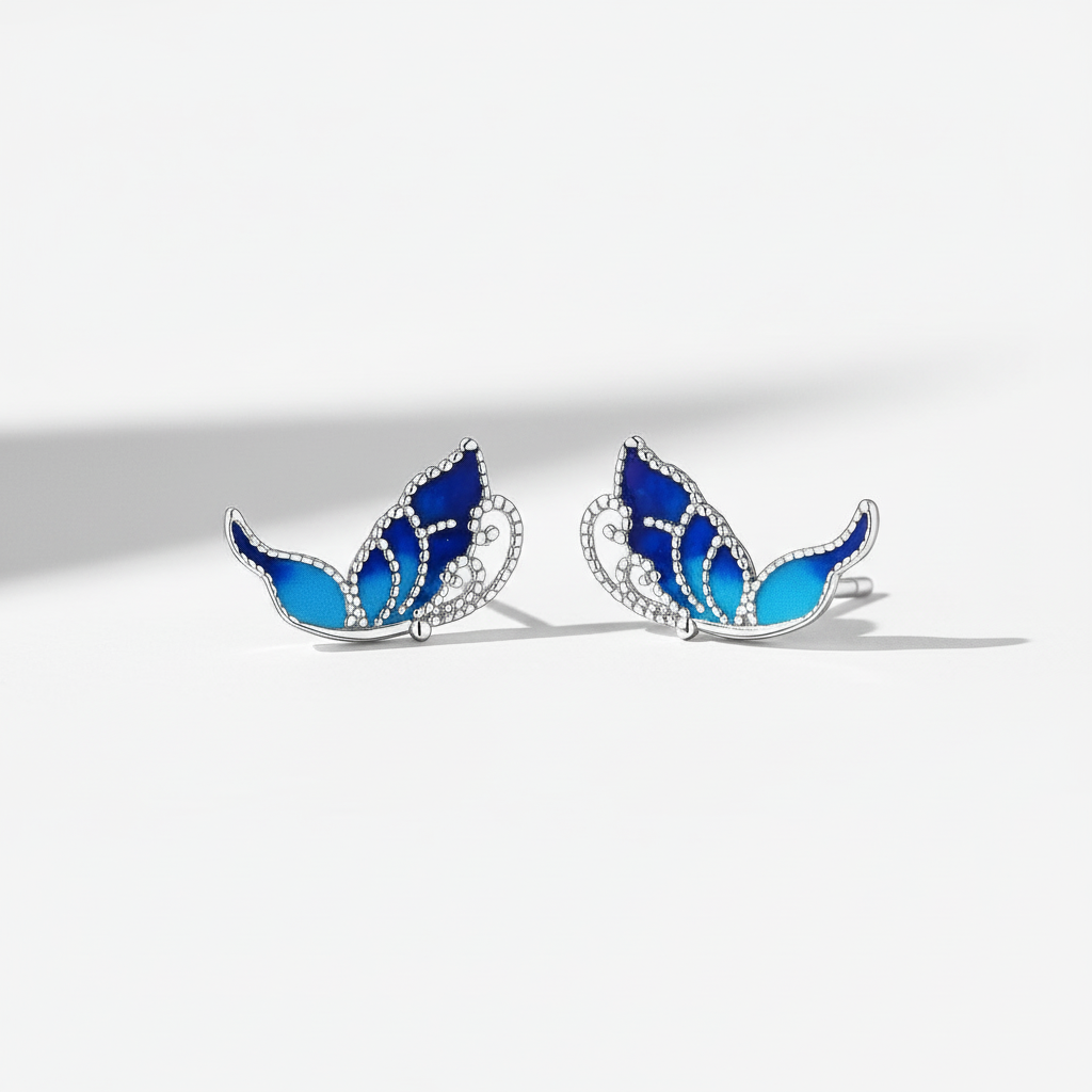 Blue enamel detailing on a 925 sterling silver butterfly wing earring, capturing a nature-inspired aesthetic
