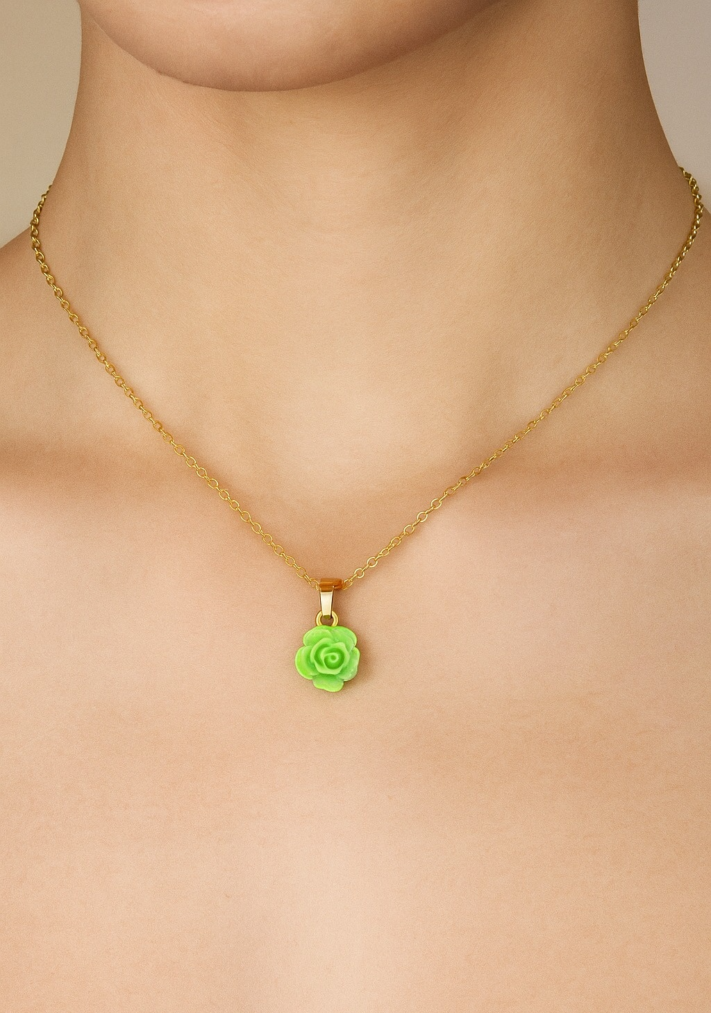 Necklace with a green rose pendant on a woman neck