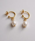 Gold hoop earrings with white pearls 
