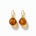Pair of glass bead charms for earrings with golden elementsl on a white background