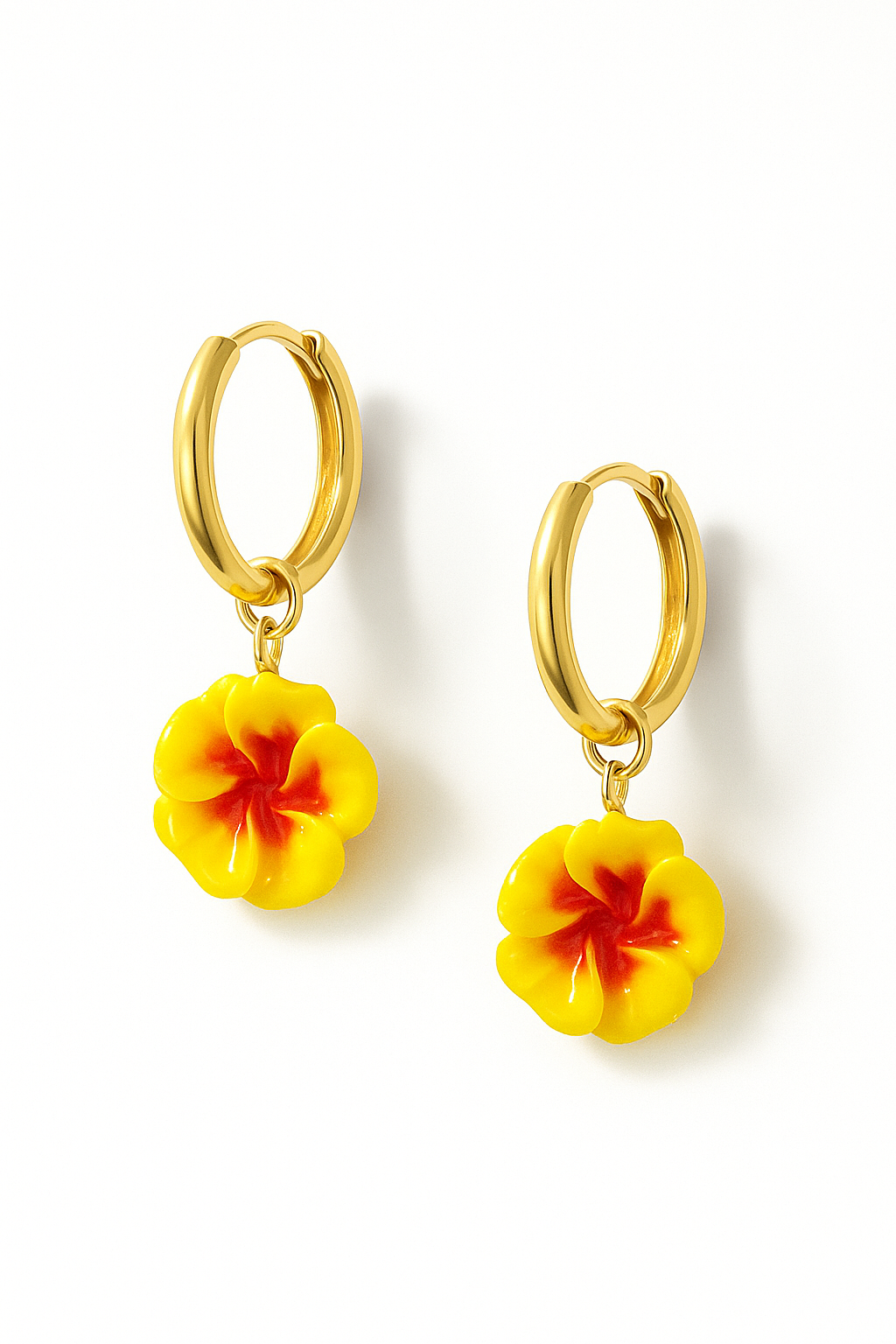 Gold hoop earrings with yellow flower-shaped charms on a white background