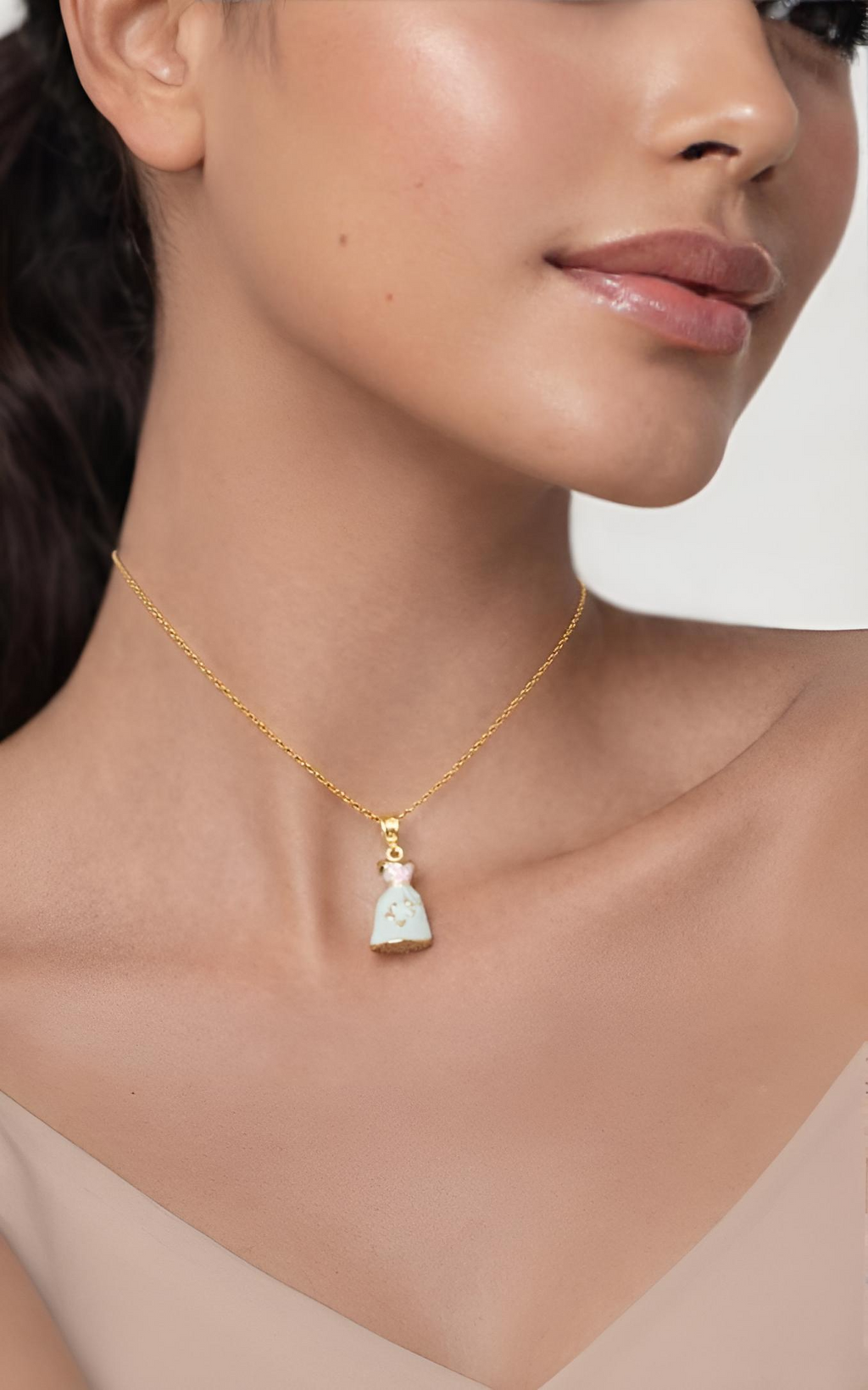 Necklace with a dress pendant worn by a model 