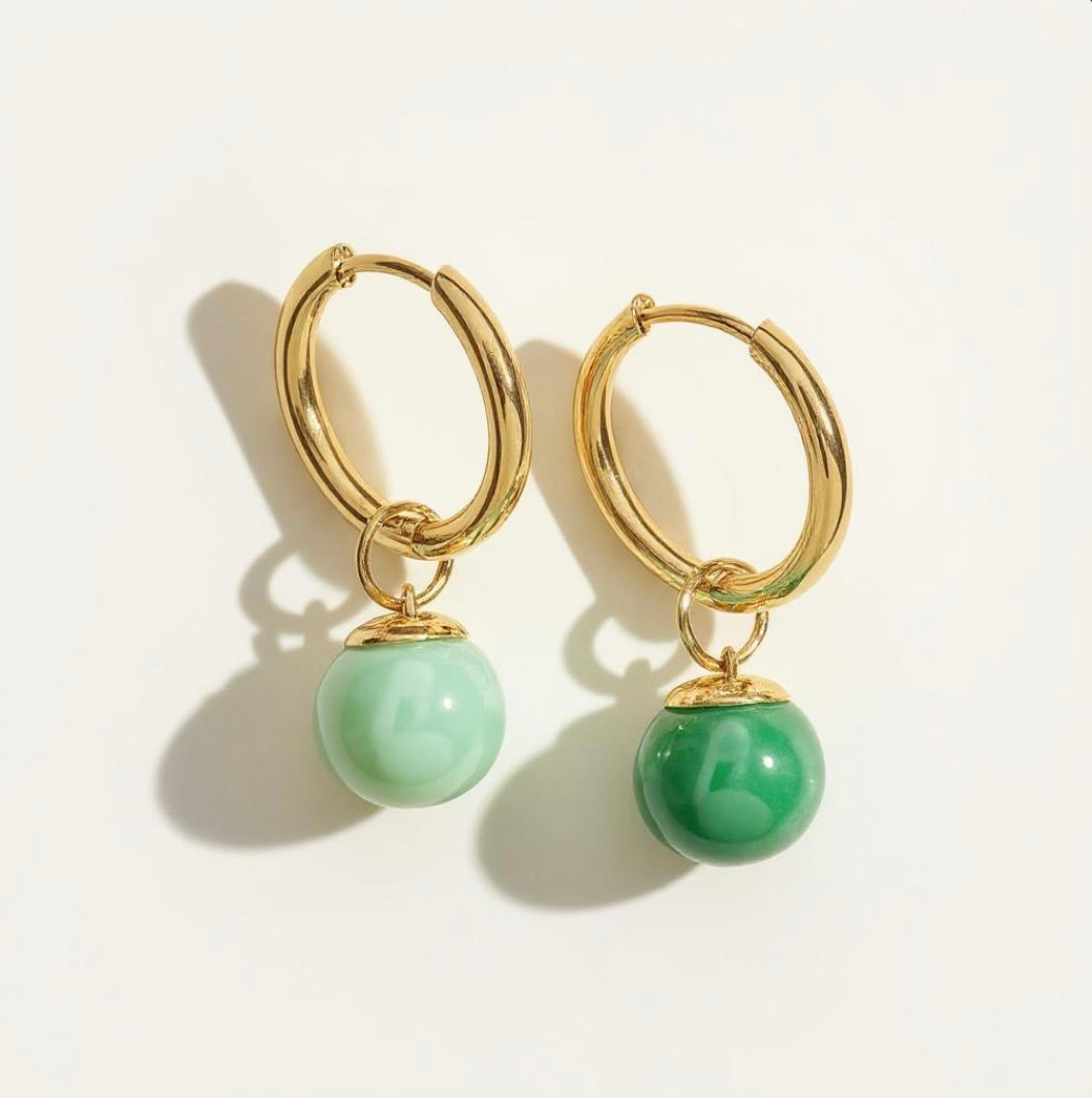 Gold hoop earrings with attached green bead dangles