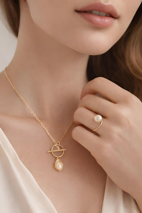 Pearl necklace and ring on a model 