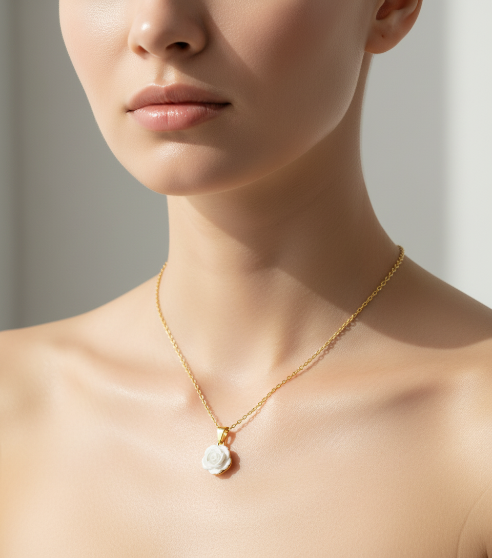 Elegant female model with gentle appearance with a gold necklace and white flower pendant on a light background