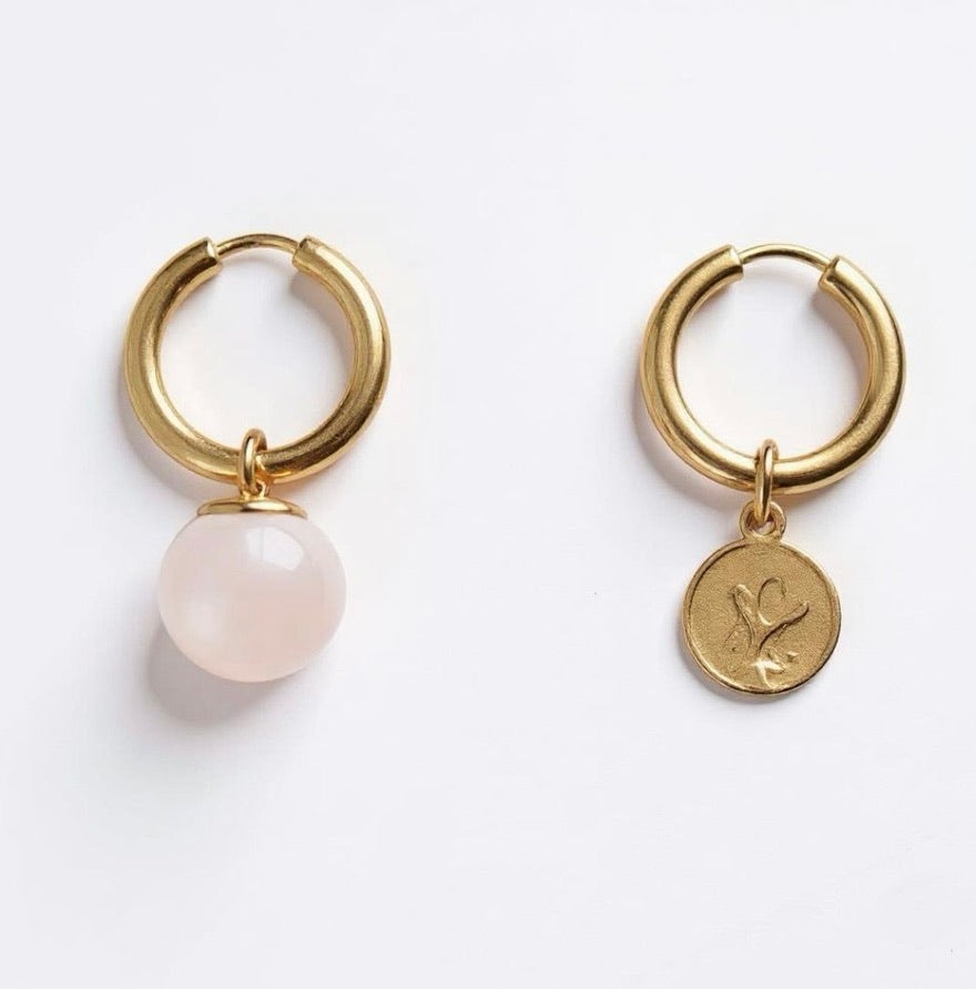 Gold hoop earrings with a round pink quartz stone charms and gold charm
