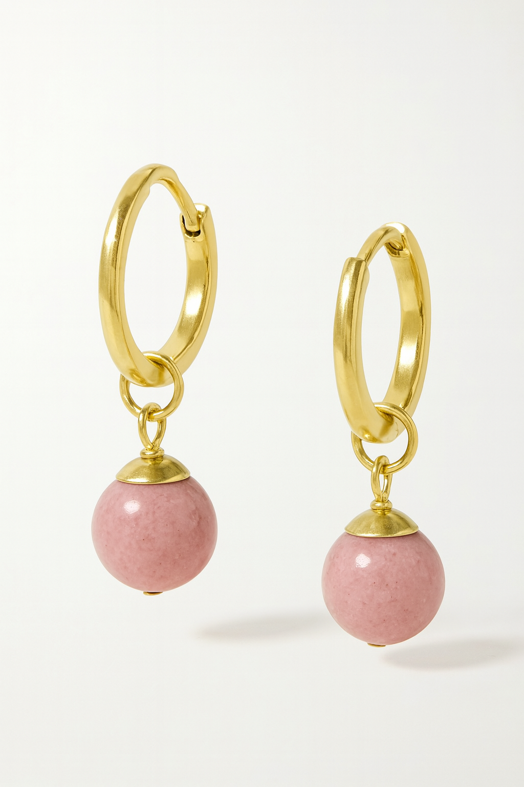 Gold hoop earrings with pink rhodochrosite bead charms on a white background