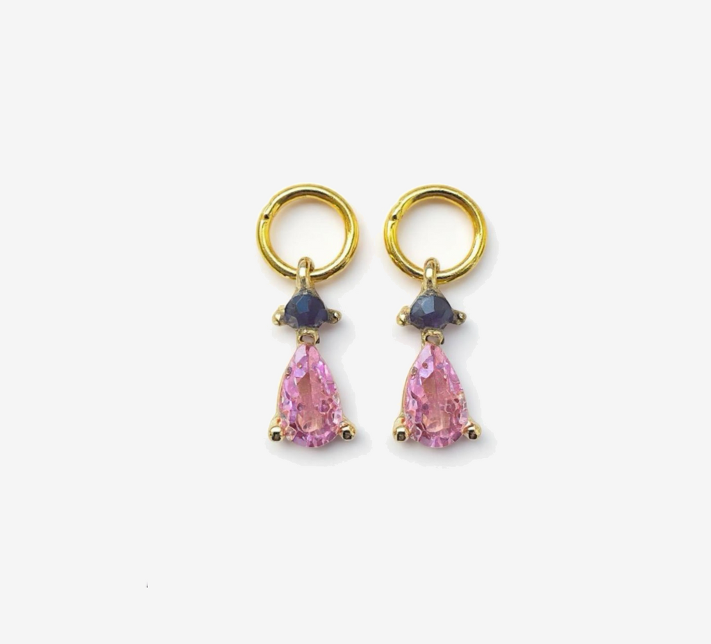 Pair of gold earrings with pink teardrop-shaped gemstones on a white background