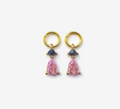 Pair of gold earrings with pink teardrop-shaped gemstones on a white background