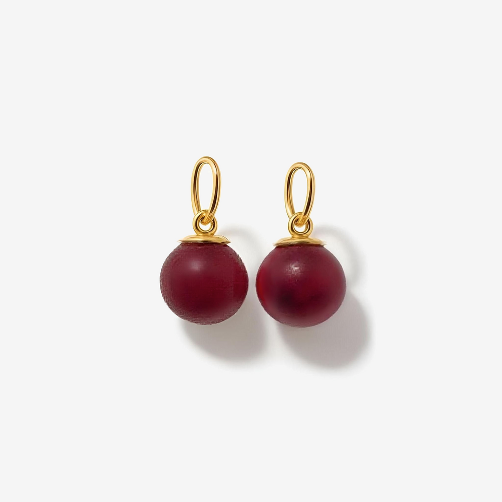 Pair of red beaded charms earrings with gold hooks on a white background
