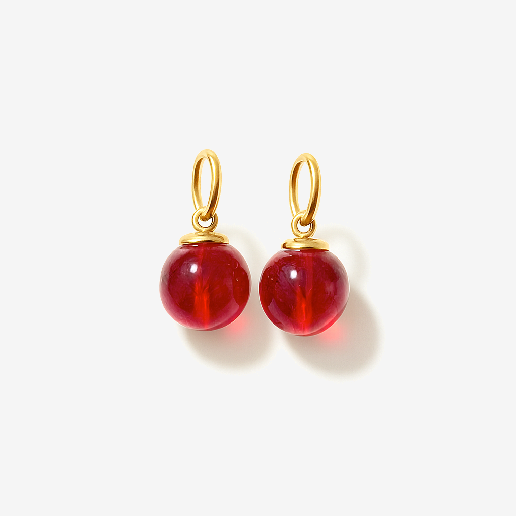 Charms for earrings with red jade beads on a white background