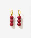 Pair of red beaded charms for earrings with gold hooks on a white background