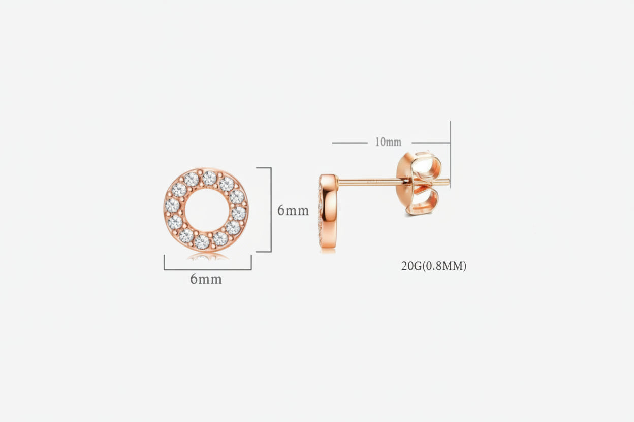 Rose gold earrings with clear gemstones on a white background.