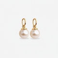 Pair of pearl dangle charms for earrings with gold hooks on a light gray background