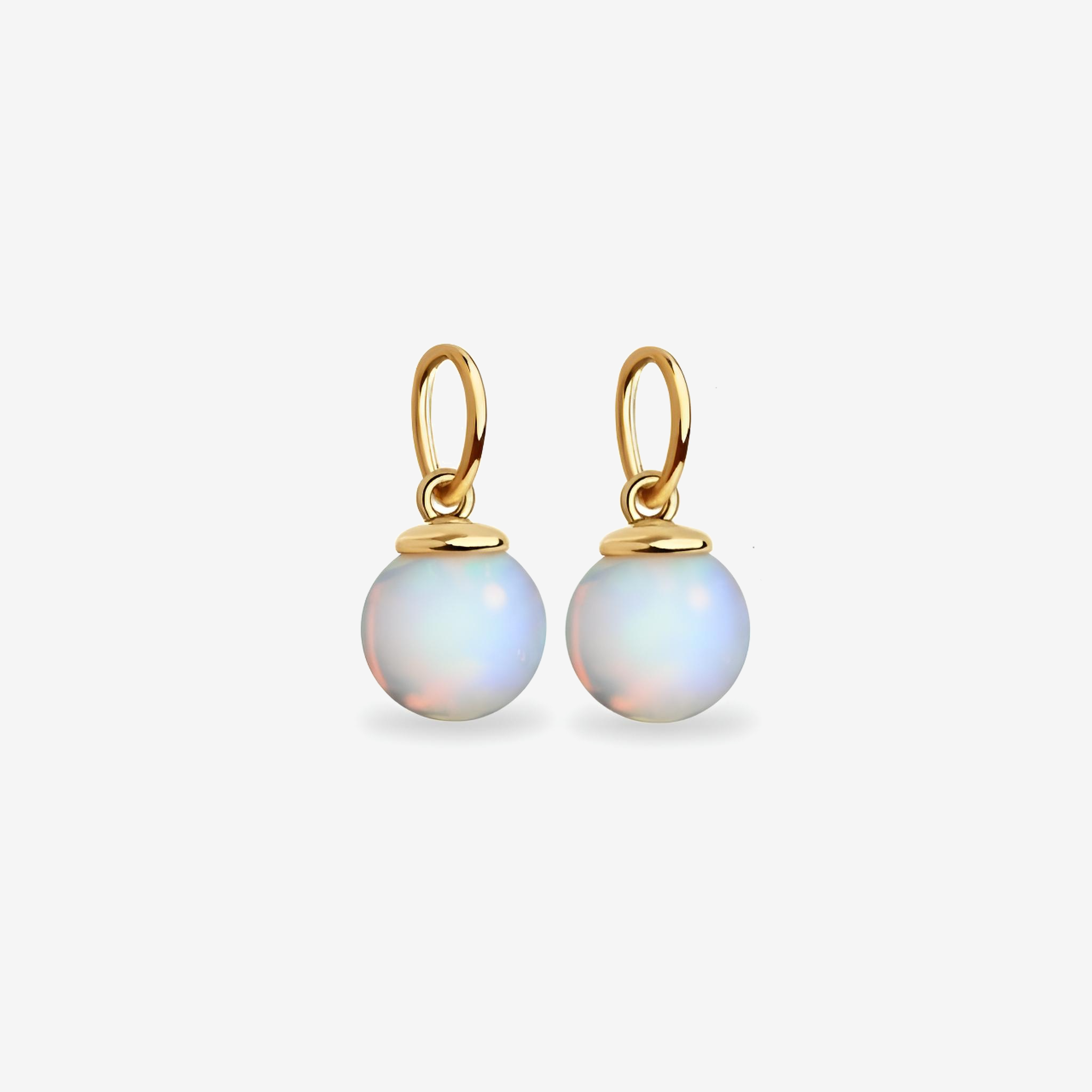 Gold earrings with round, light-colored gemstones on a white background