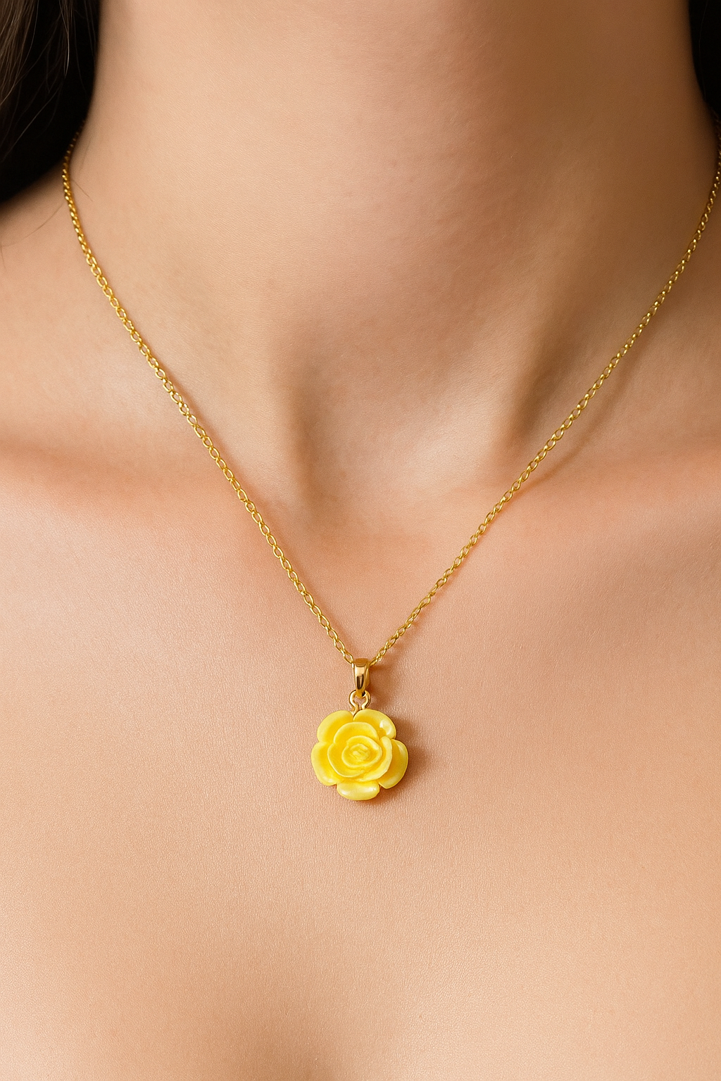 Gold necklace with a yellow flower pendant 